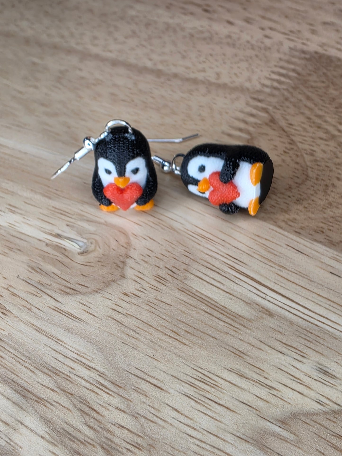 Knitted penguin holding heart