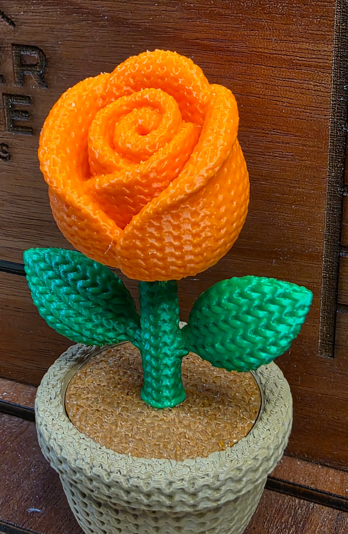Knitted orange rose flower pot