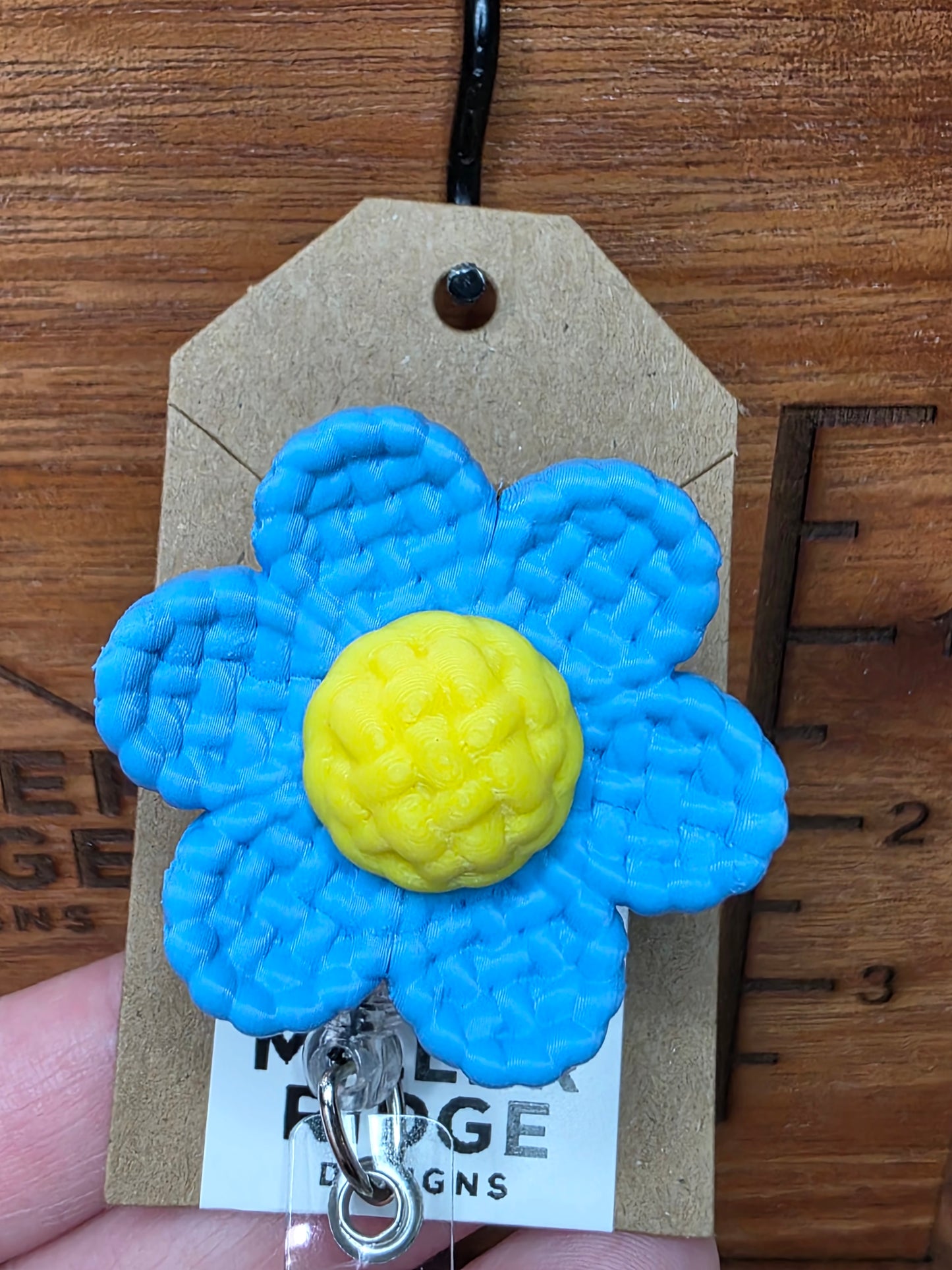 Blue daisy badge reel