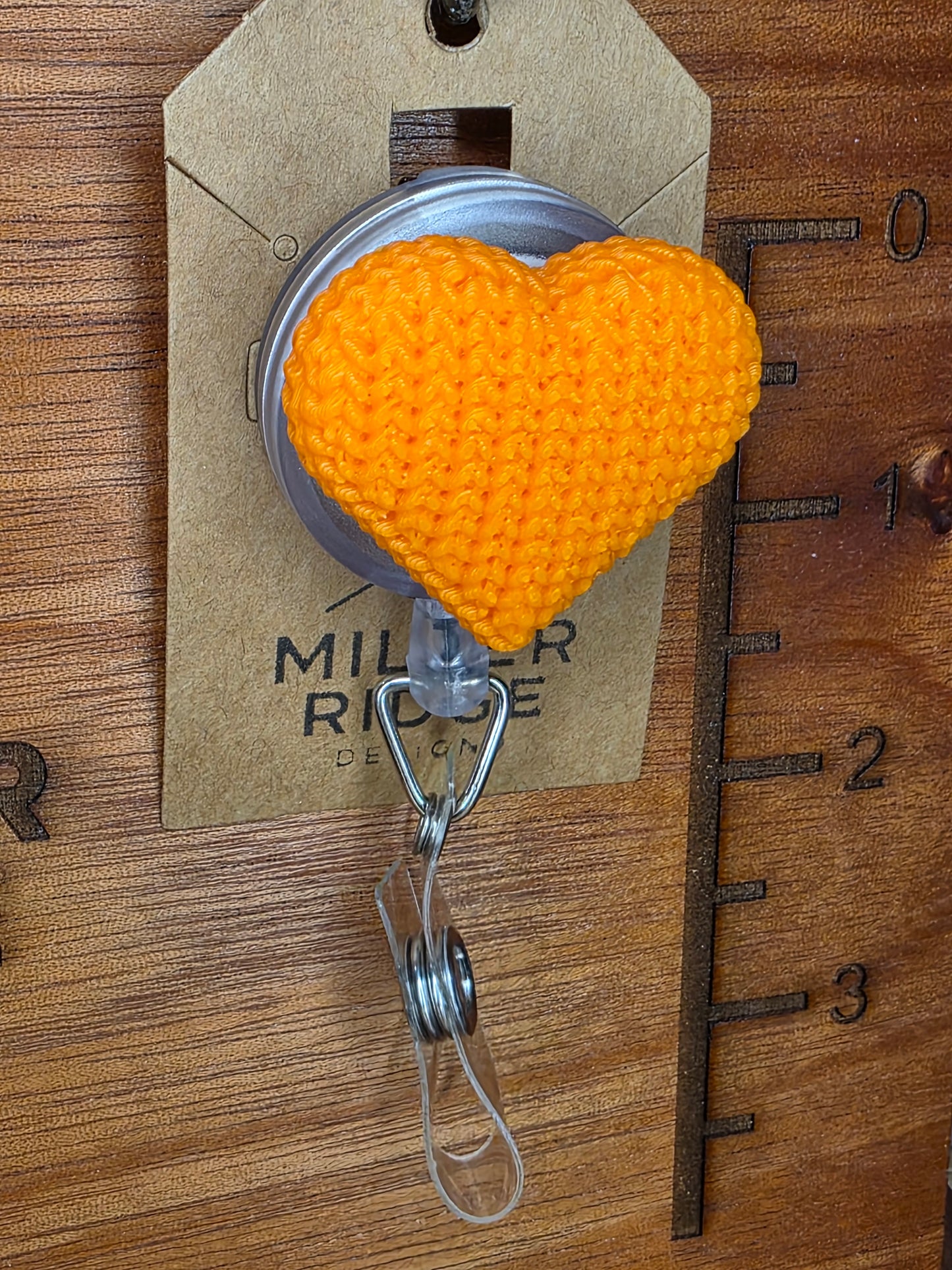 Orange knitted heart badge reel