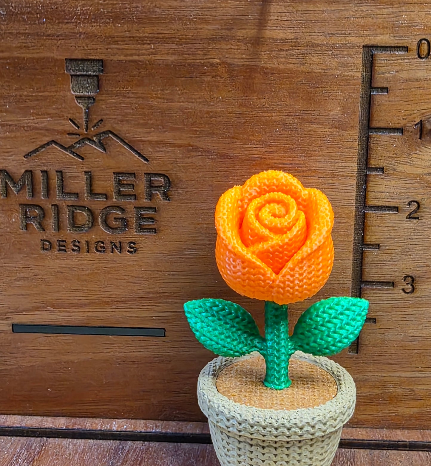 Knitted orange rose flower pot
