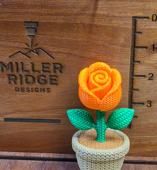 Knitted orange rose flower pot