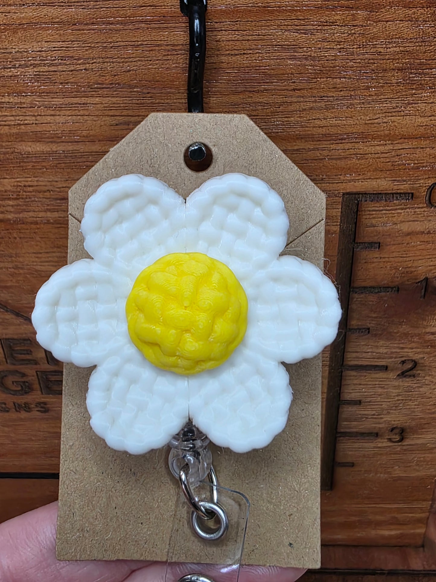 White daisy badge reel