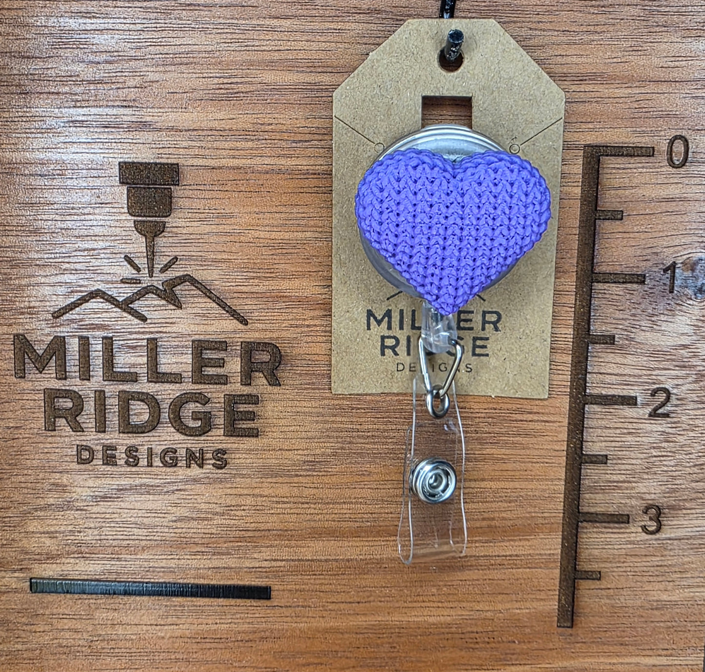 Purple knitted heart badge reel
