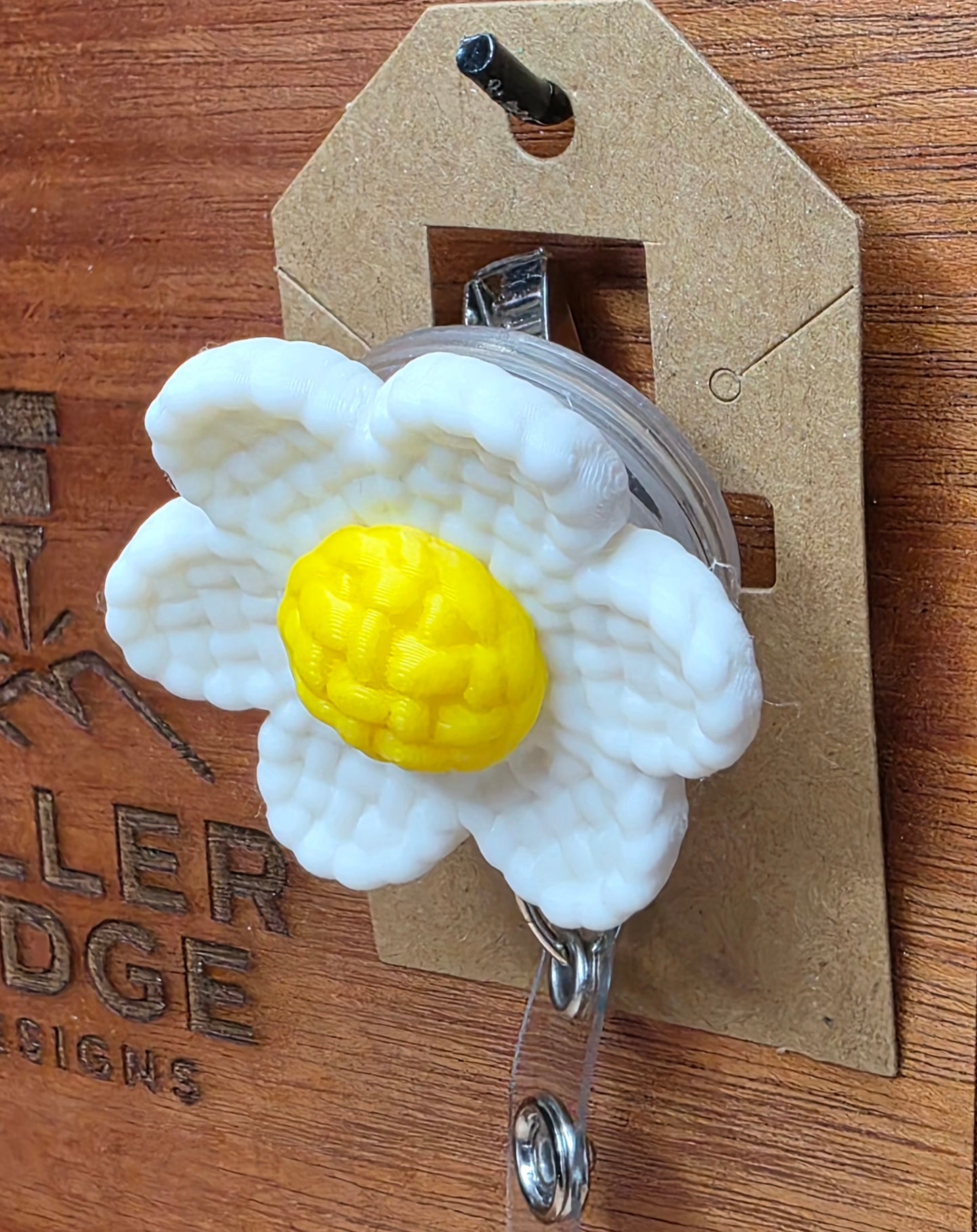 White daisy badge reel