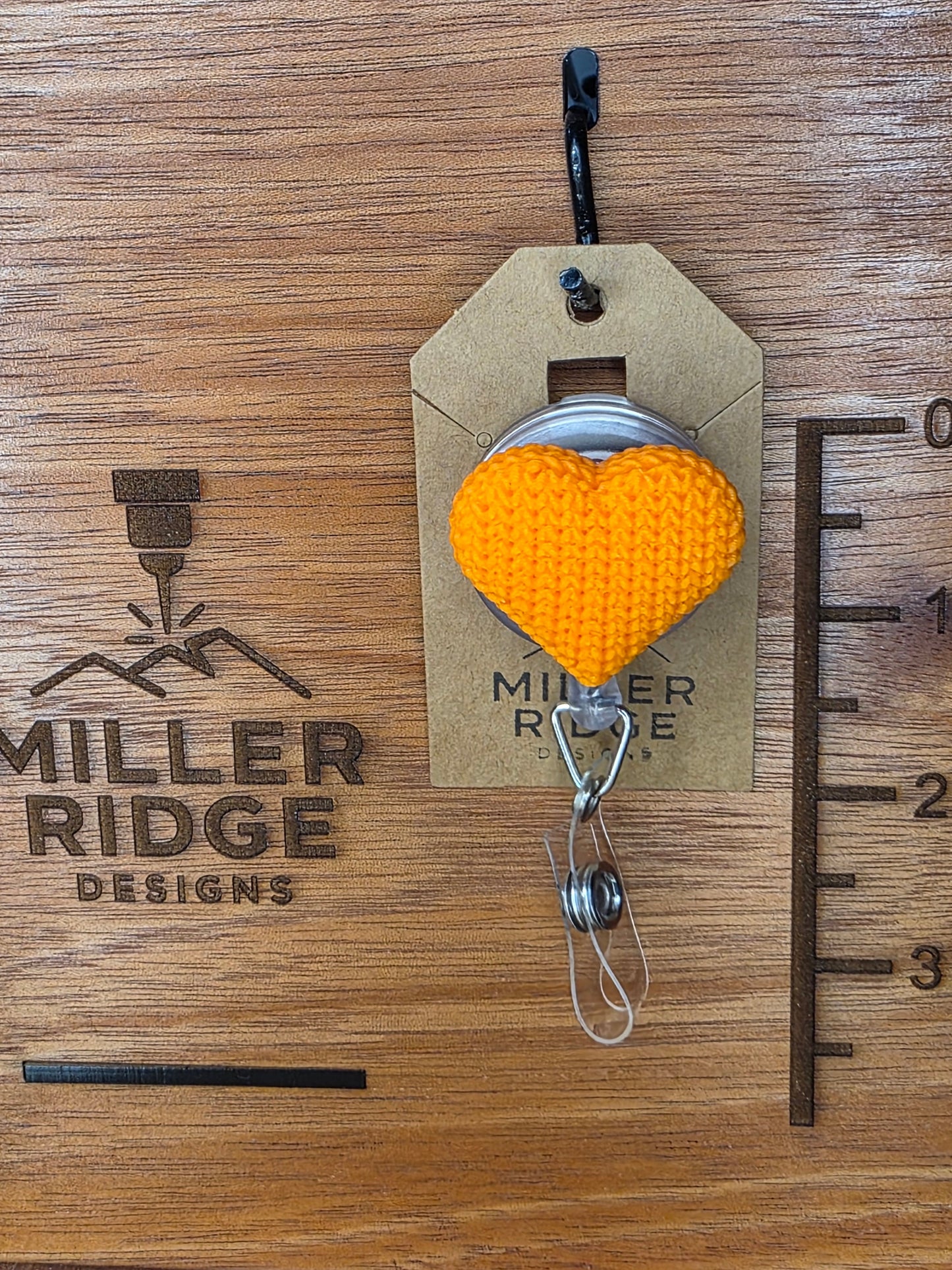 Orange knitted heart badge reel