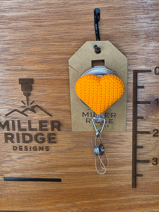 Orange knitted heart badge reel