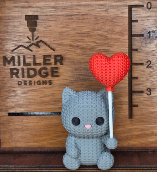 Knitted cat with balloon heart