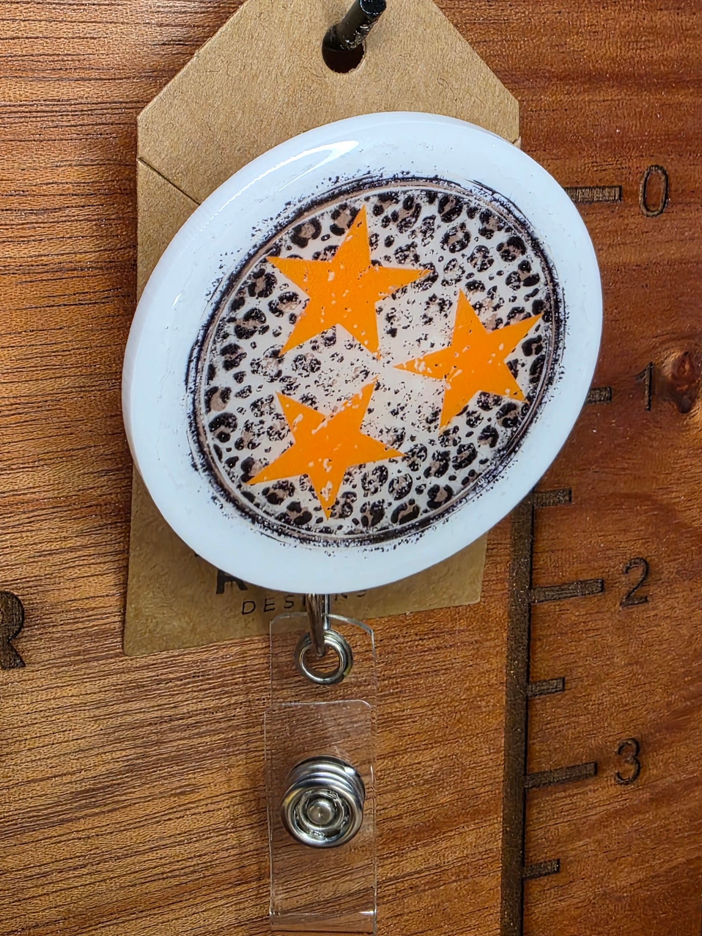 Tristar and animal print badge reel