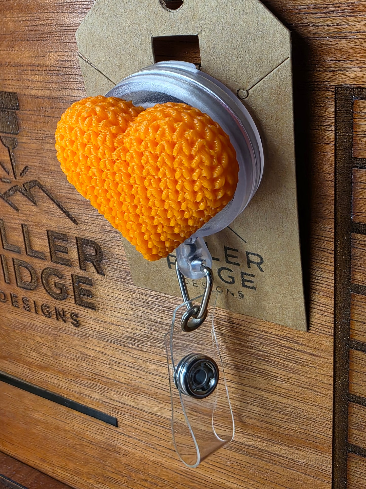 Orange knitted heart badge reel