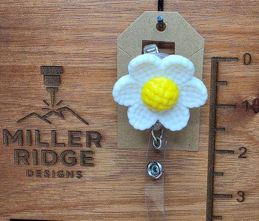 White daisy badge reel