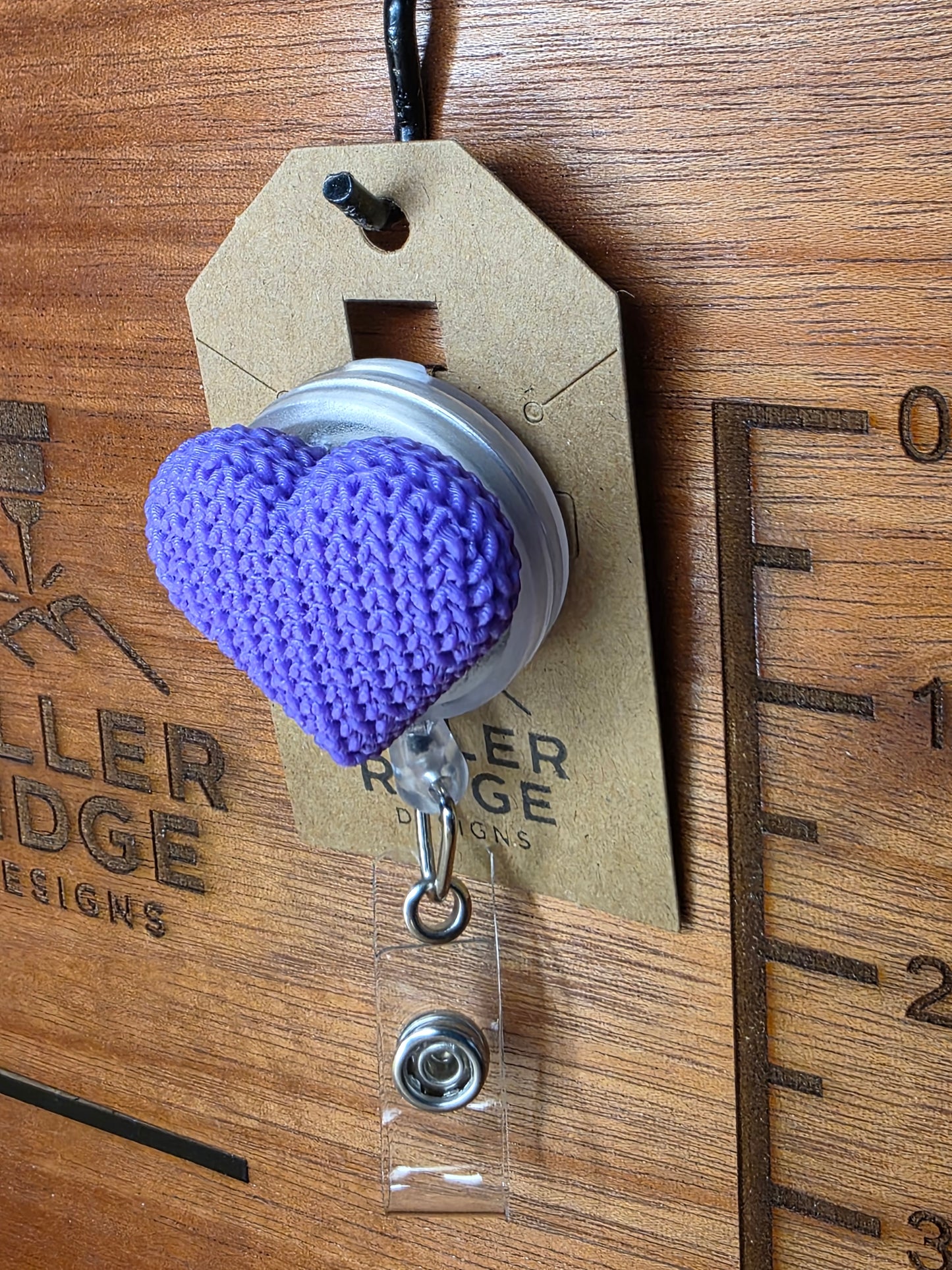 Purple knitted heart badge reel