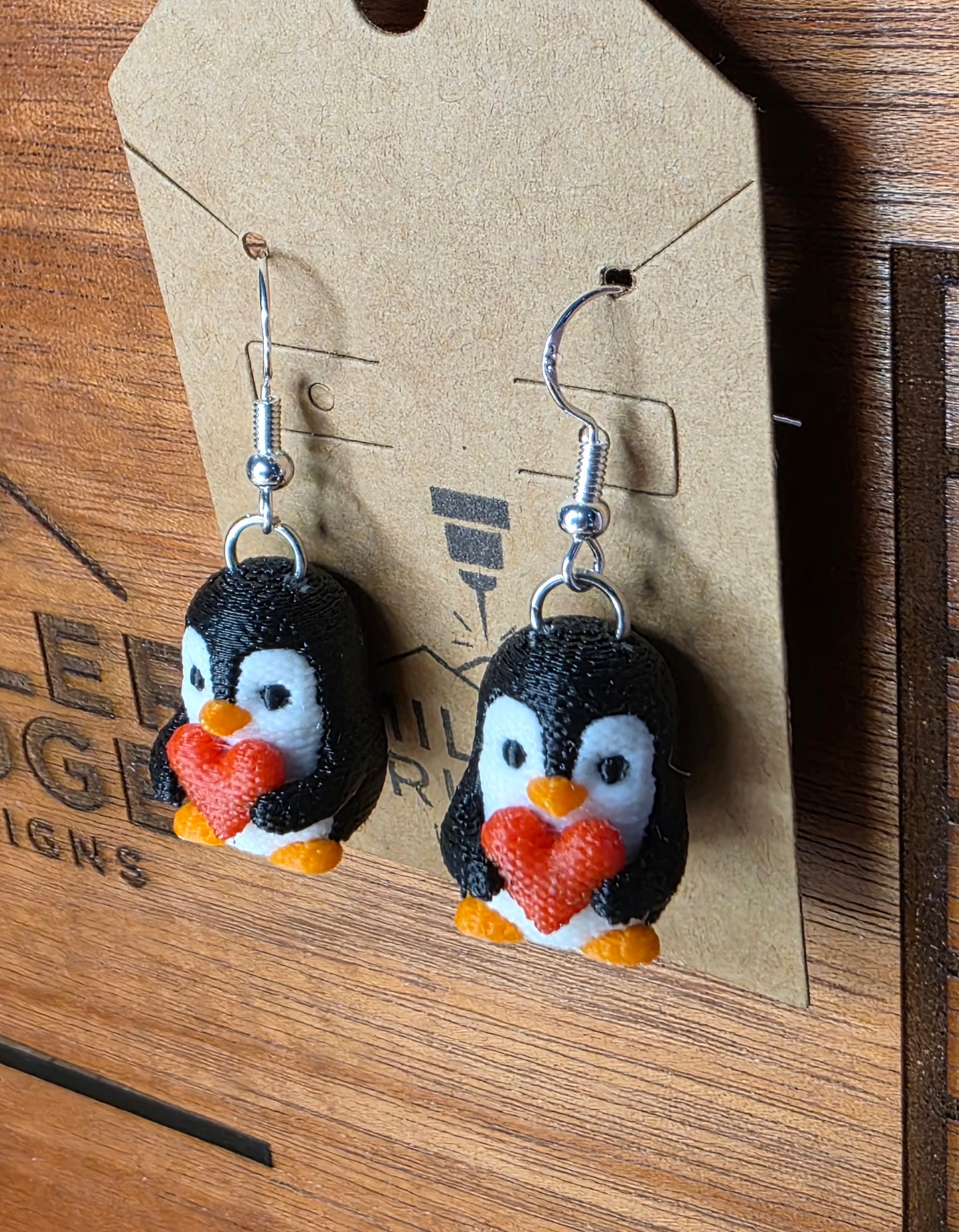 Knitted penguin holding heart